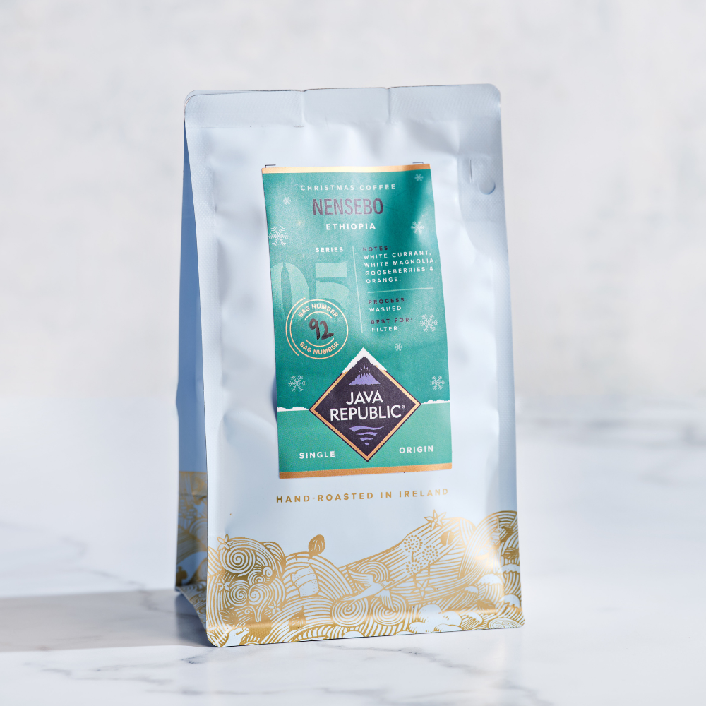 Nensebo Christmas Coffee Bag with Green label recommended for filter coffee - behind is a snowy background